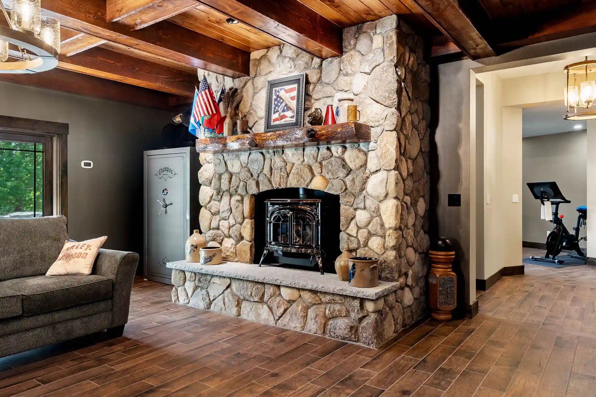 Photo of a finished basement with a fireplace and furniture.