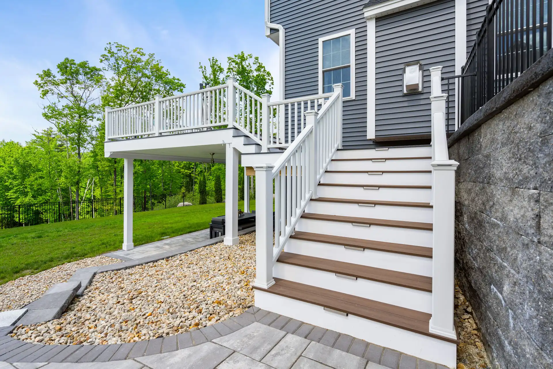 elevated deck with railing and steps with in-step lighting.