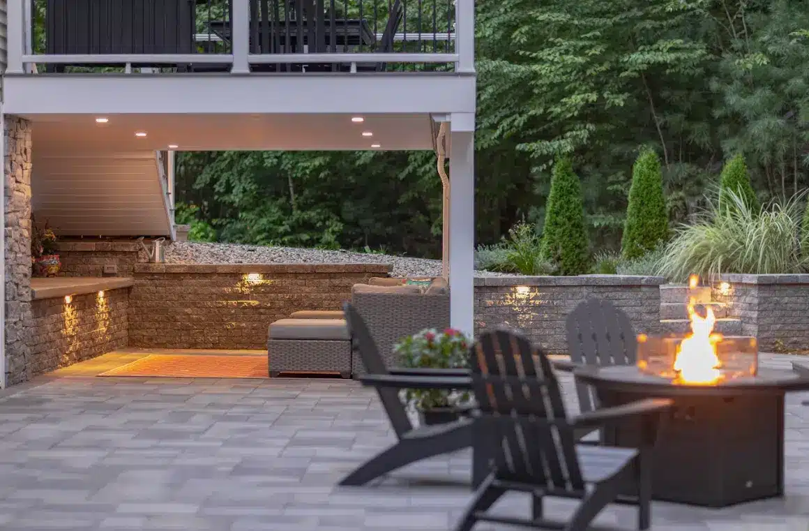 elevated deck with a patio that features an outdoor entertainment area and a fire pit