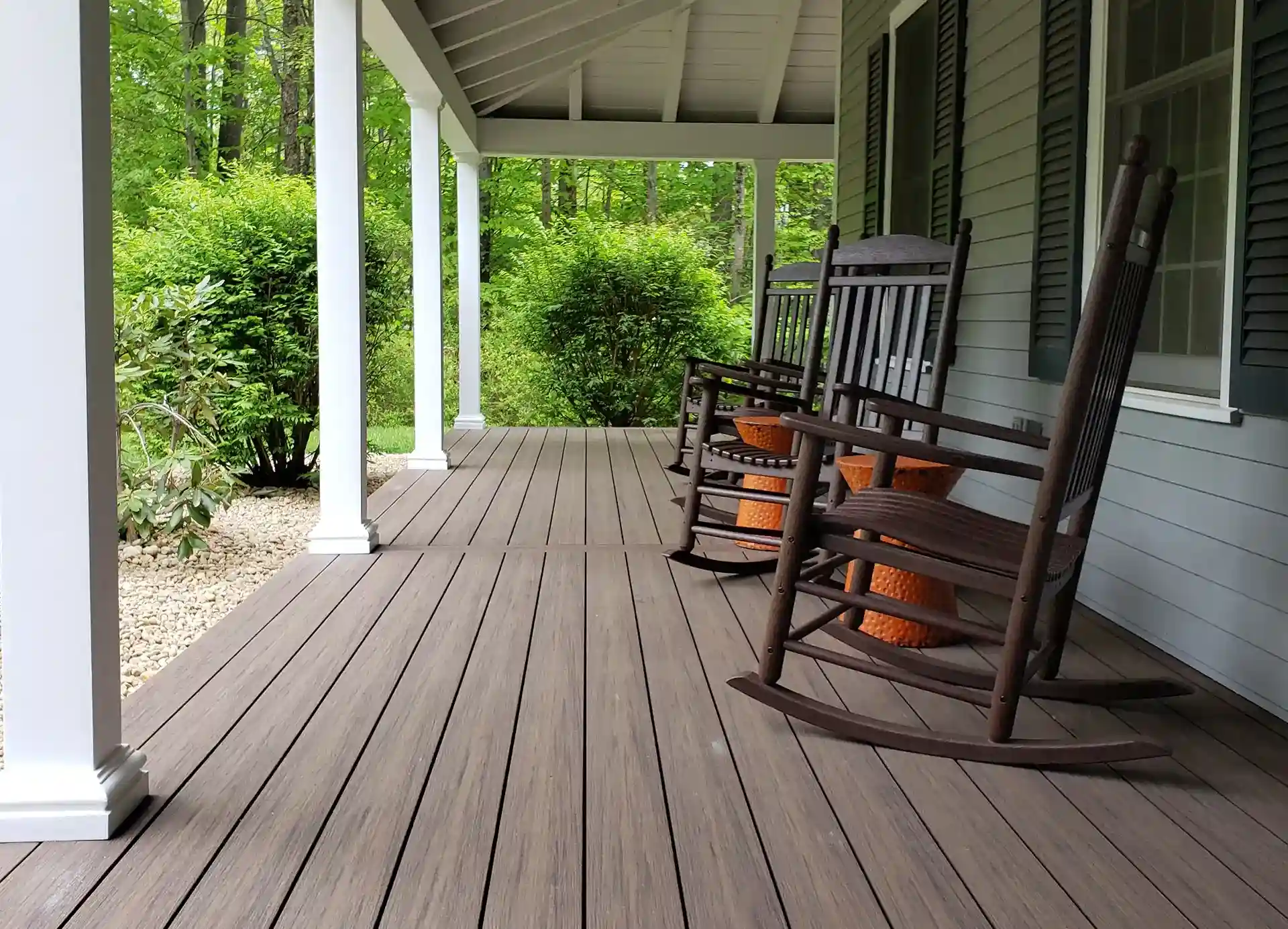 photo of a covered porch with column and rocking chairs - Porch Builders in New Hampshire Villandry Home