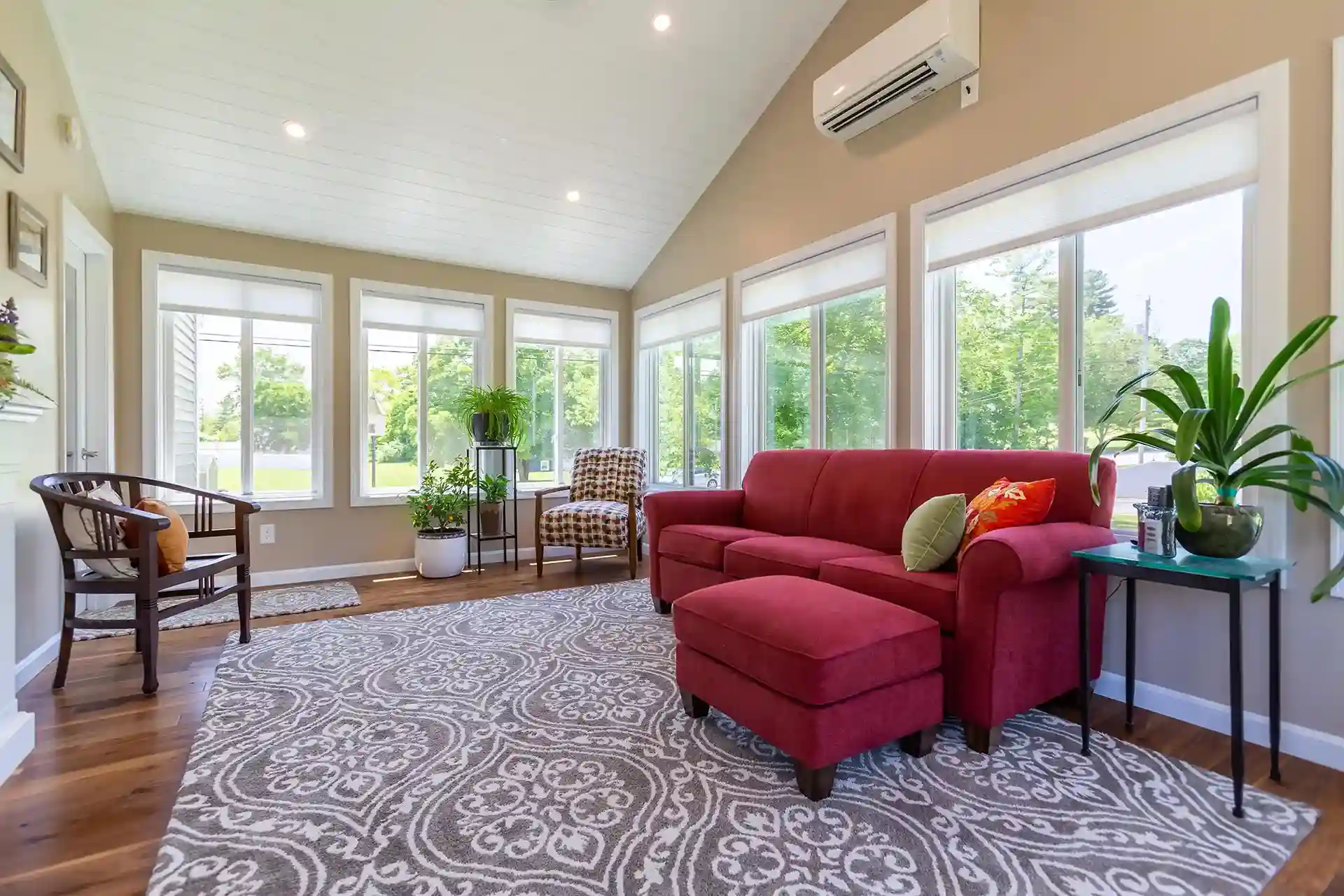 Interior of sunroom with furniture and throw rug Hopkinton NH - Four-Season Sunroom builders near me in southern new hampshire