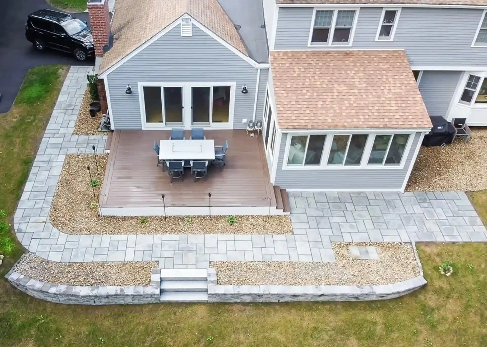 aerial view of outdoor living space project that included a 4-season sunroom, deck, and patio paver walkway - Three-Season rooms builder and Four-Season Rooms Contractors near me