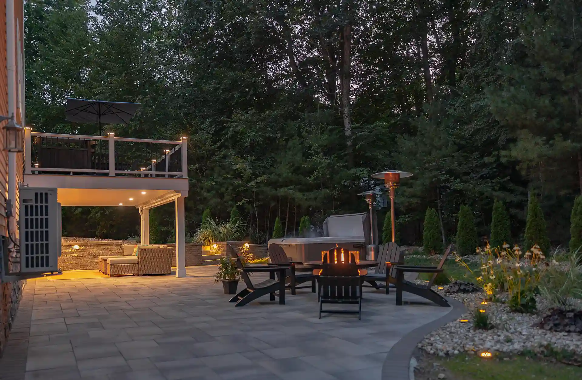 photo of an elevated deck with a patio below and an entertainment area under the deck
