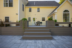 Front view of mineral based composite deck with steps, built-in benches and flower boxes